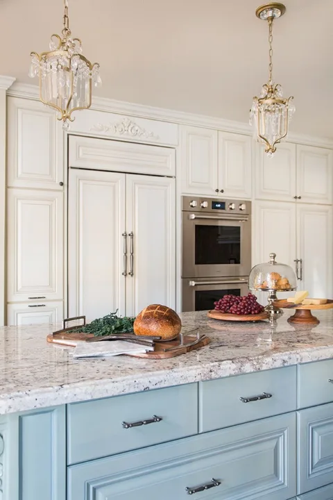 Traditional Kitchen Remodel by HartmanBaldwin - Hartman Baldwin Custom kitchen remodel featuring blue and white cabinetry, brass-accented light fixtures, and stainless steel appliances.