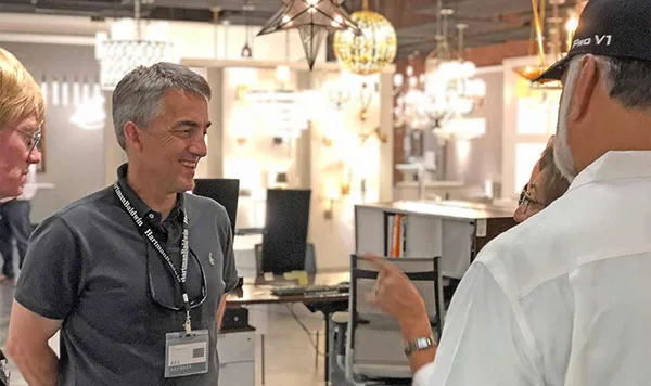 HartmanBaldwin staff talking to customers surrounded by lighting fixtures.