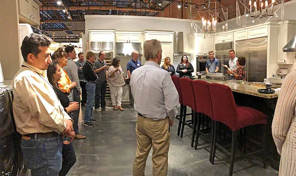 HartmanBaldwin staff and potential clients in showroom.