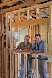 HartmanBaldwin staff presenting new project inside with exposed framing.