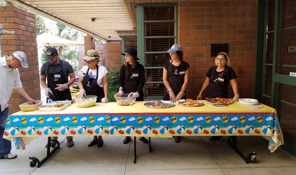 HartmanBaldwin staff working at a food table providing food to volunteer staff.