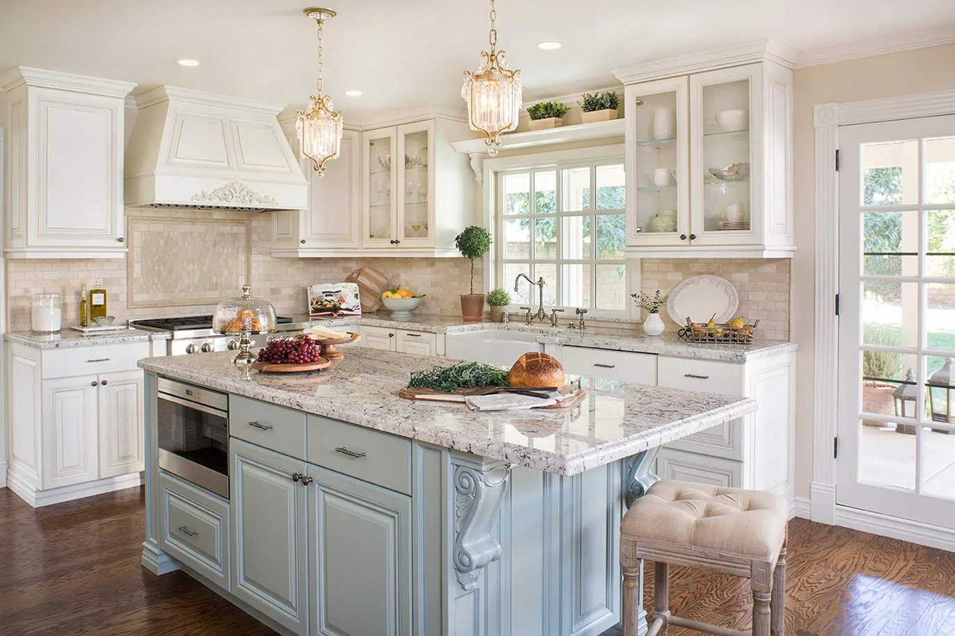 Remodeled kitchen feature granite countertops, decorative trim, and glass-faced cabinets.