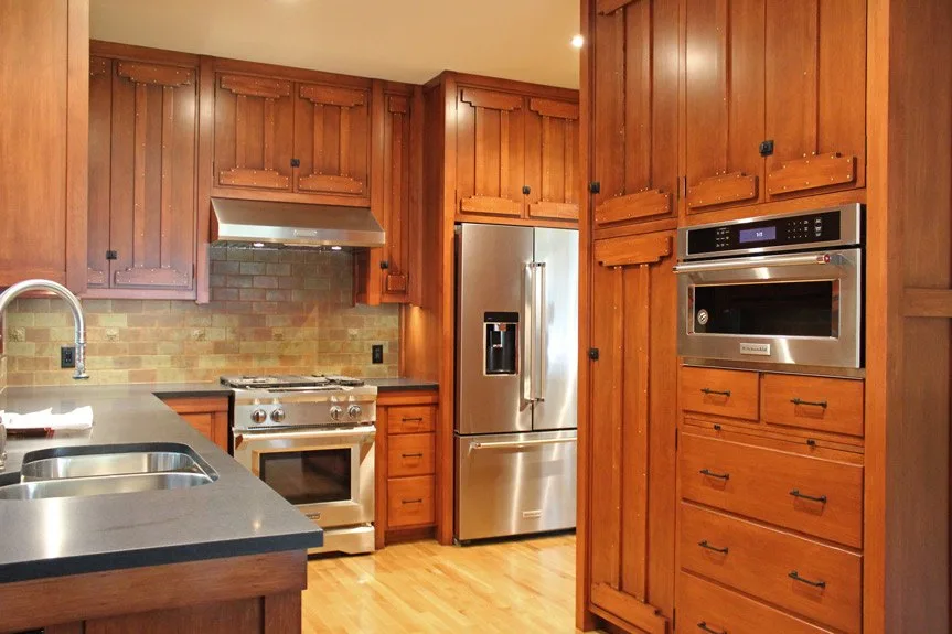 Canyon Residence After Kitchen - Hartman Baldwin After image of Canyon residence project's kitchen. Wood cabinetry, stainless steel appliances, wood floor.