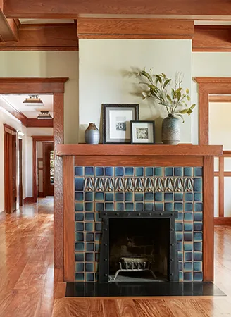 Handsome and stately, this fireplace shows off Motawi’s lovely tile accent row. - Hartman Baldwin