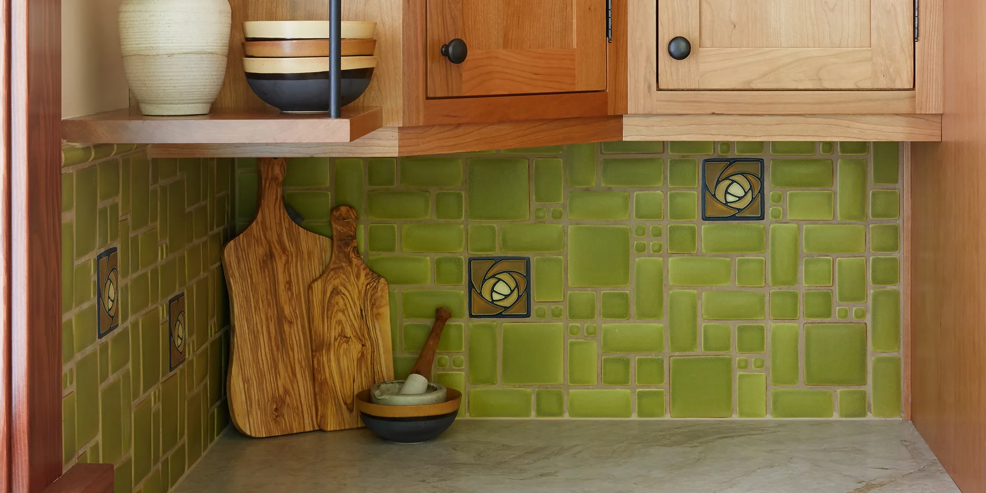 HartmanBaldwin Mira Monte Residence Craftsman Kitchen Remodel Detail Banner - Hartman Baldwin Kitchen remodel with wood cabinets, green back splash, and granite countertops.