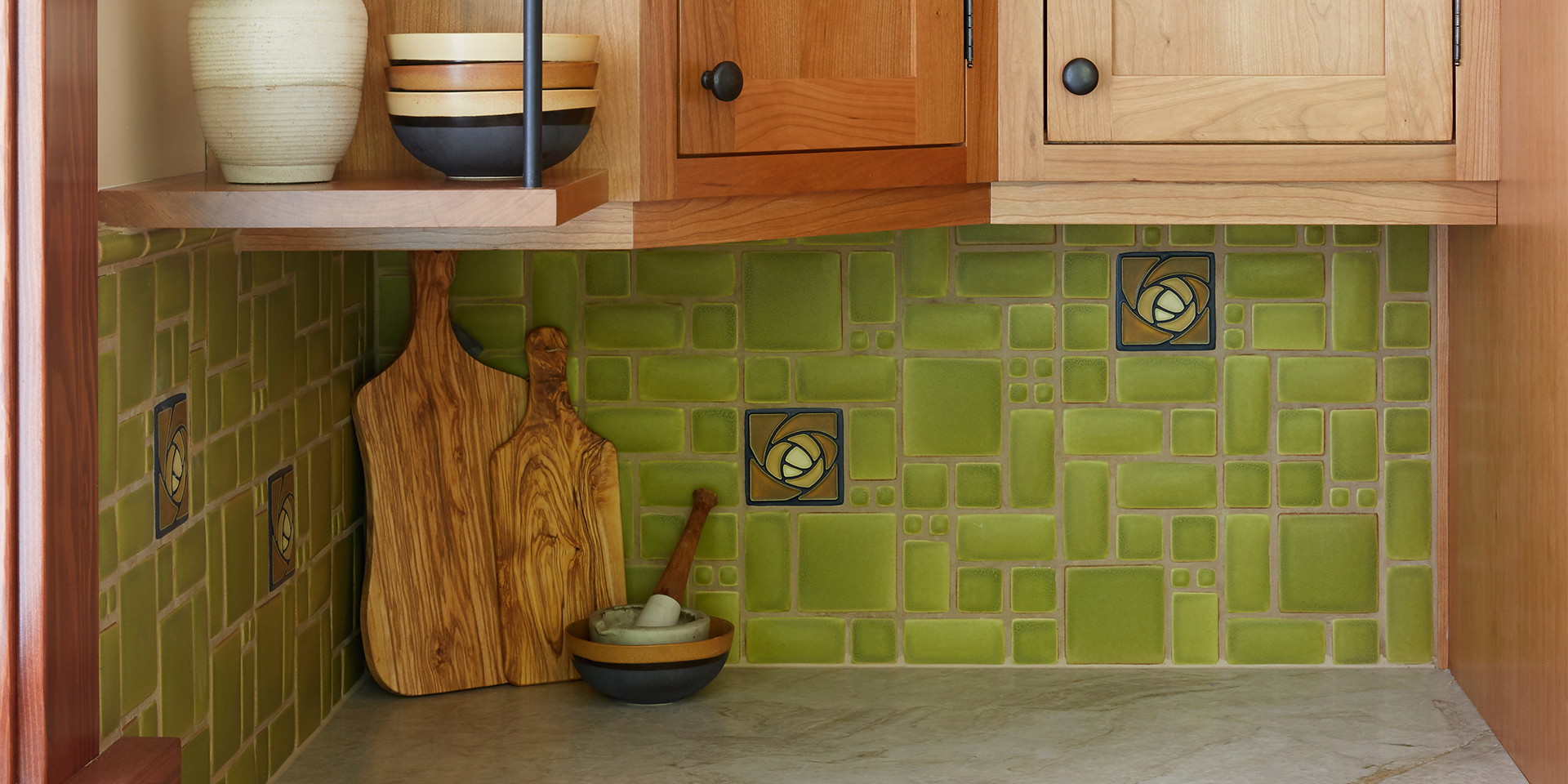 Kitchen remodel with wood cabinets, green back splash, and granite countertops.