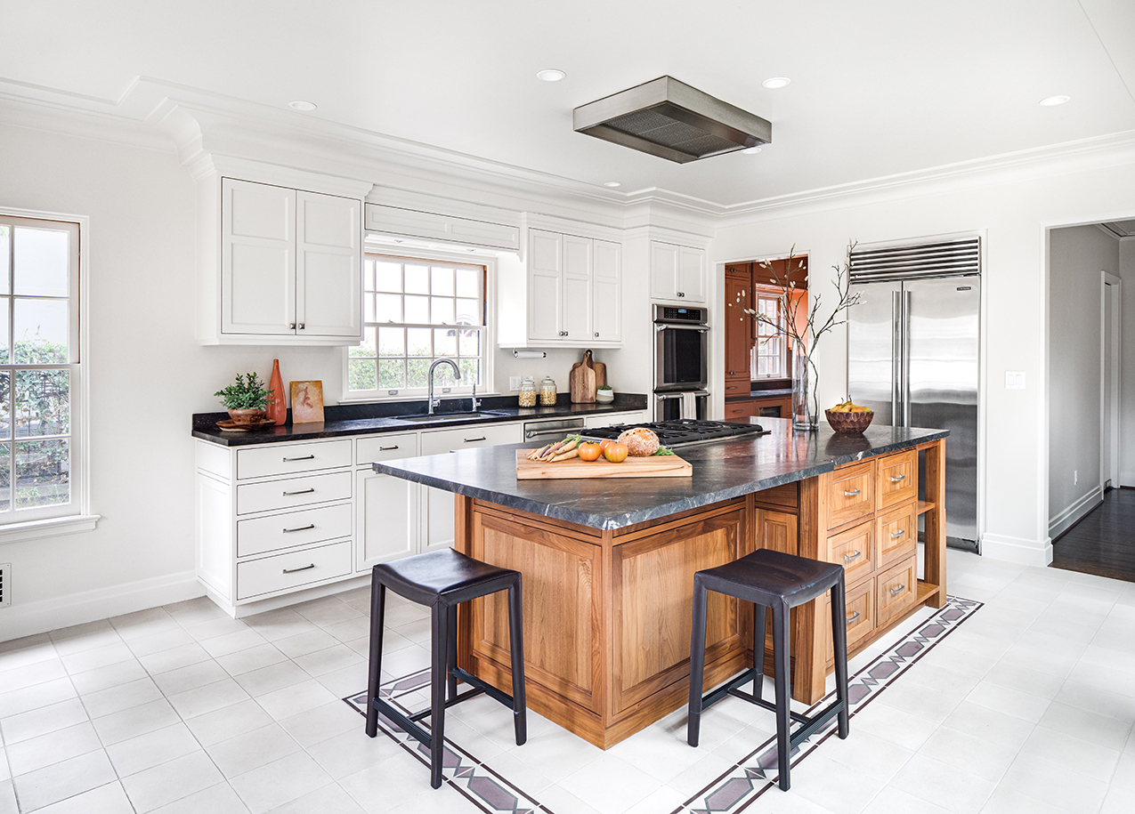 Luxurious English cottage kitchen remodel in Southern California featuring an Edgewood kitchen island and white cabinets