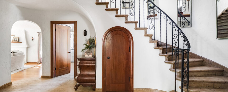 Entryway with spiral staircase, coat closet, and hallway table