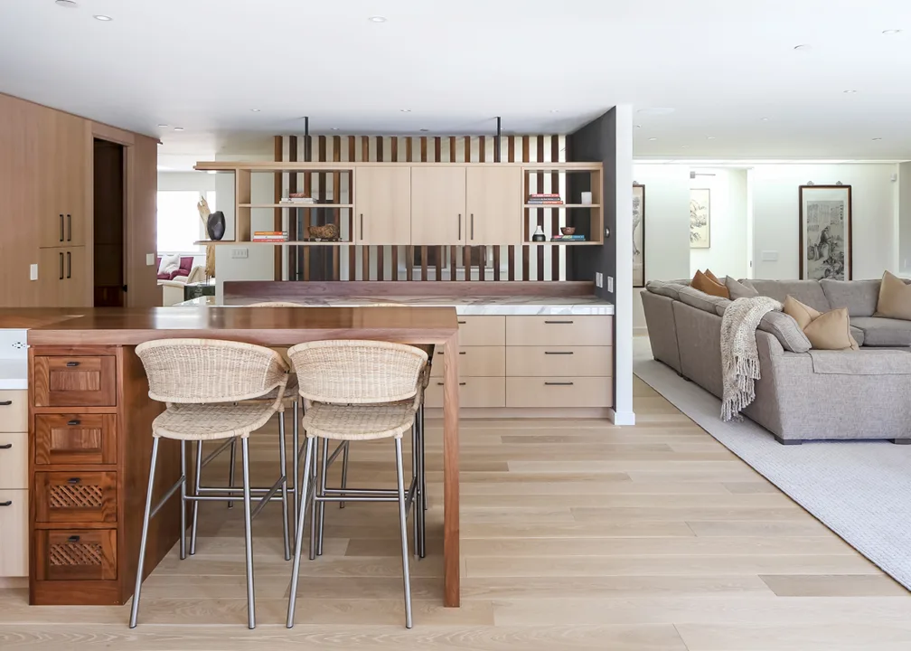Stylish kitchen with fine wood cabinets and island and a living room, remodeled with a design/build firm.