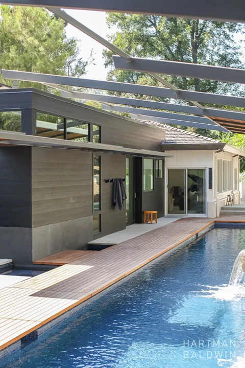 HartmanBaldwin San Rafael Residence Back Patio and Lap Pool - Hartman Baldwin Modern California home remodel new backyard with teak paneled patio, hot and cold plunge pools, and luxury lap pool with waterfall and retractable steel shade structure