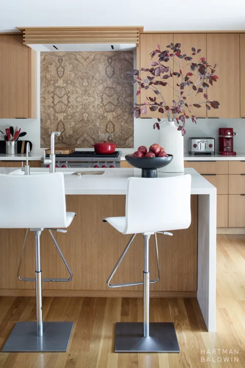 HartmanBaldwin Oak Knoll Residence Mid-Century Modern Kitchen Renovation Vertical - Hartman Baldwin Mid-Century Modern kitchen renovation with waterfall-edge central island, oak slab-style cabinetry, and book-matched wood veneer backsplash