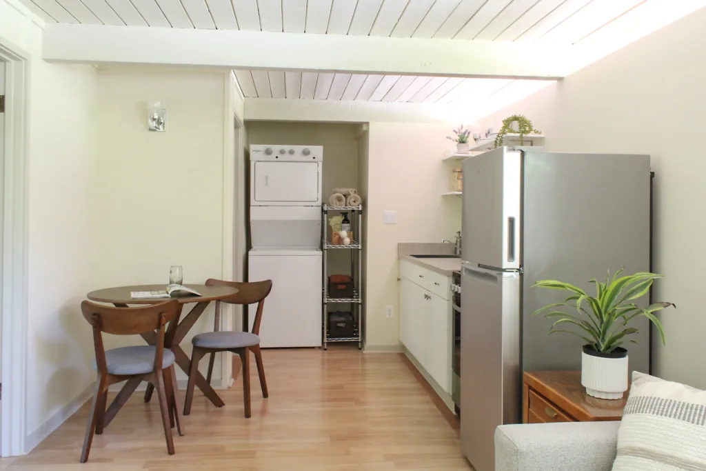 ADU interior with kitchen, laundry nook, and dining table