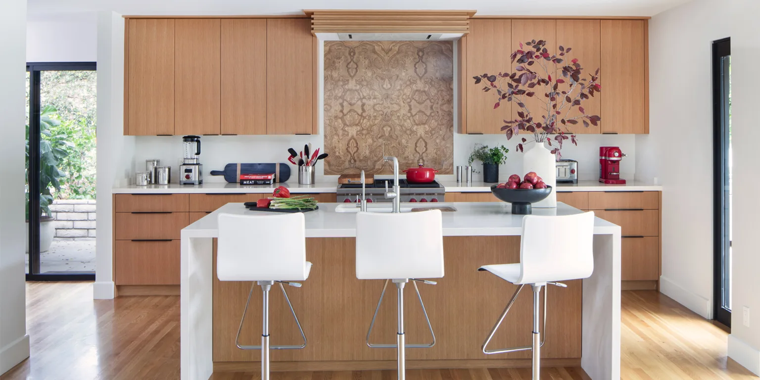 Renovated Mid-Century Modern kitchen and dining room with wide sliding glass doors open to the backyard