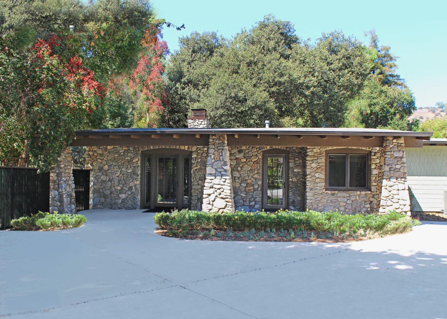 Remodeled Craftsman-style home with cobblestone walls and pillars