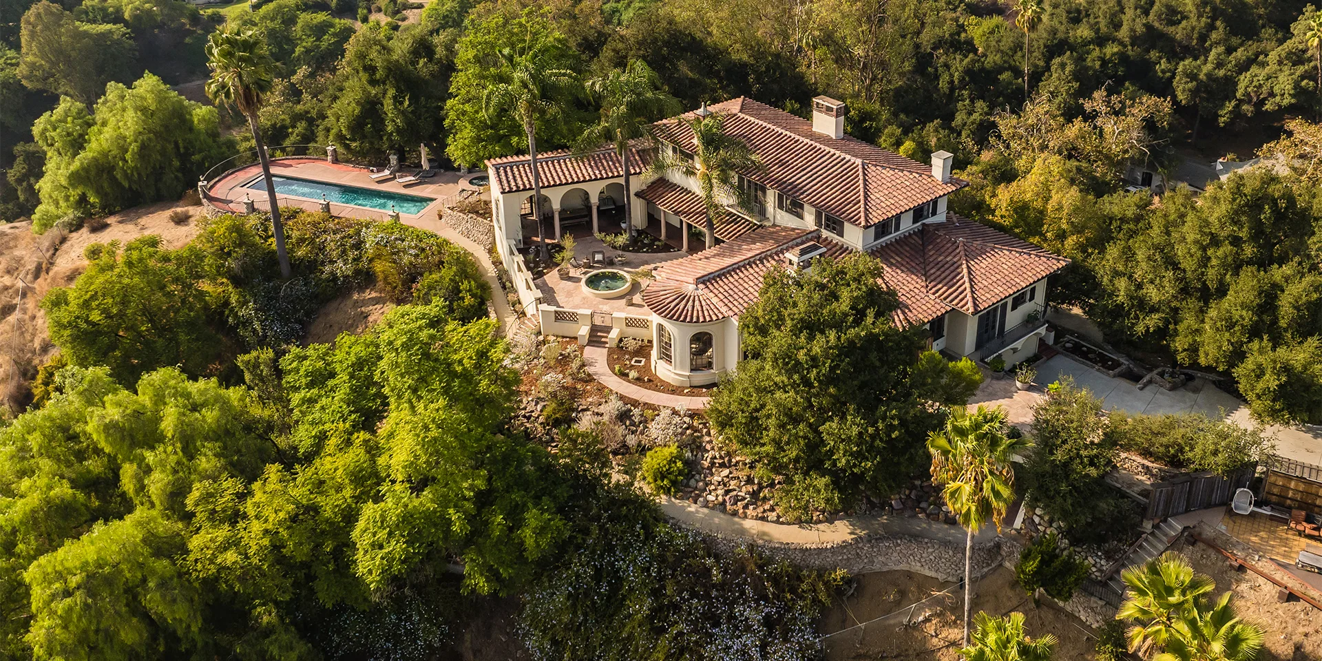 HartmanBaldwin Robles Residence Spanish Style Hilltop Estate - Hartman Baldwin Ariel view of a hilltop Spanish-style California estate with a pool and courtyard