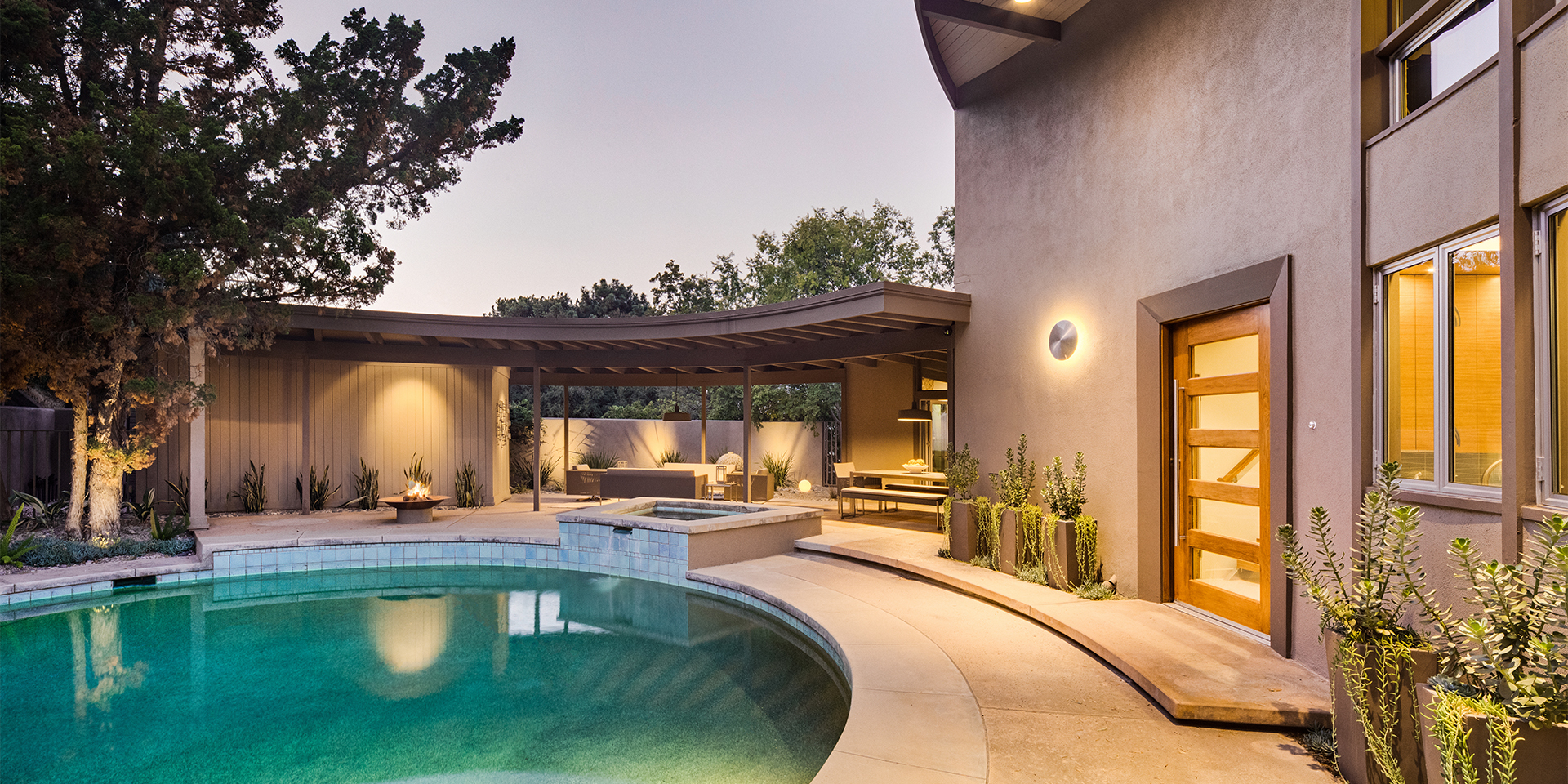 HartmanBaldwin Robin Hill Residence Mid Century Modern Remodel Exterior Pool - Hartman Baldwin Unique circular Mid-Century Modern home, pool, and patio at dusk