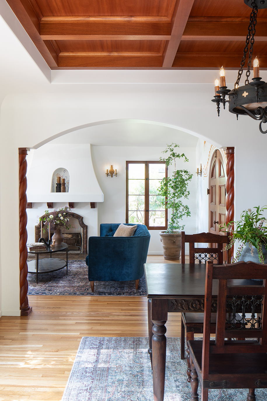 Spanish style whole home remodel dining room looking through arch into living room