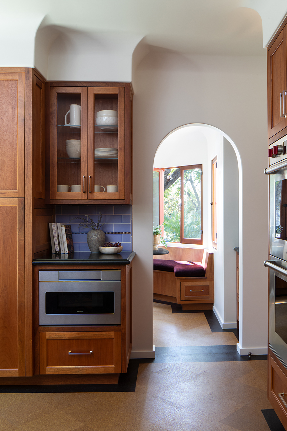 Remodeled Spanish-style kitchen with arched doorway to adjacent breakfast room